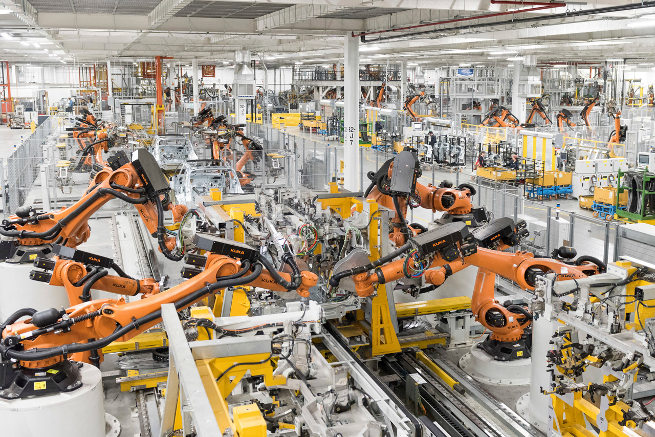 Kuka robots, under the supervision of equipment service associates, build BMW's on the body shop production line. 